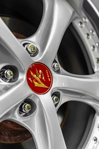 a close up of a wheel on a car, inspired by Eugène Brands, silver gold red details, 7, oz series, metal chrome
