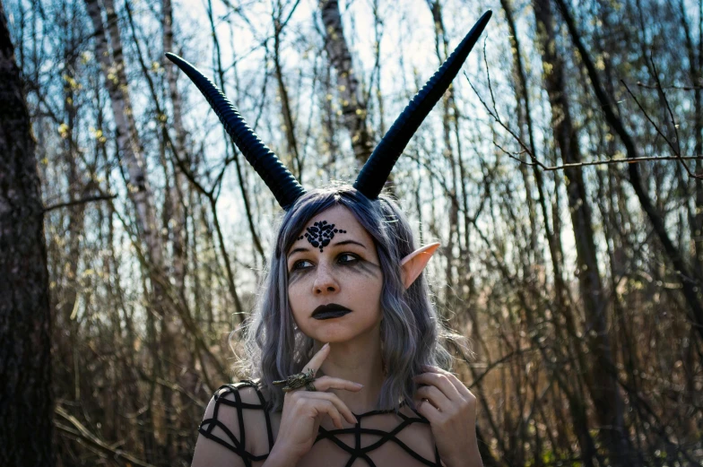 a woman with horns on her head in the woods, inspired by Xul Solar, unsplash, large antennae, pale gray skin, high quality costume, discord profile picture