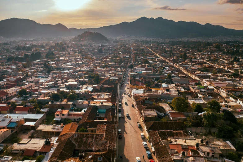 an aerial view of a city with mountains in the background, by Carey Morris, pexels contest winner, sumatraism, mexico, background image, small town surrounding, ultrawide angle cinematic view