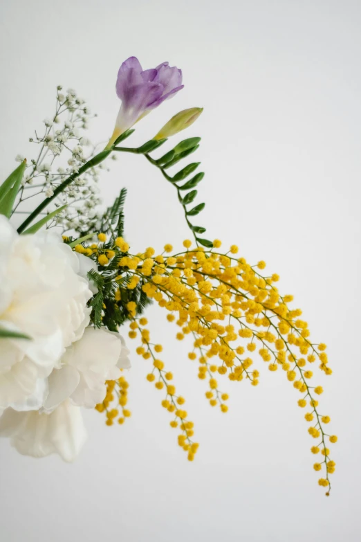 a vase filled with yellow and white flowers, a still life, unsplash, yellow and purple color scheme, detail shot, delicate embellishments, camaraderie