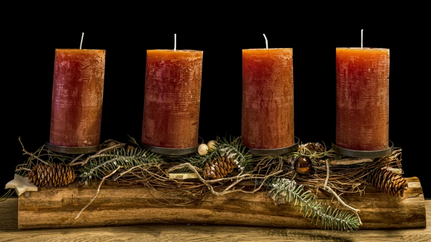 a group of three candles sitting on top of a wooden table, by Linda Sutton, trending on pixabay, folk art, sitting on a log, dark oranges reds and yellows, 🦩🪐🐞👩🏻🦳, centerpiece