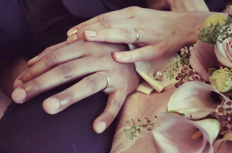 a close up of a person holding a bouquet of flowers, rings, take my hand, silver jewellery, sitting on man's fingertip