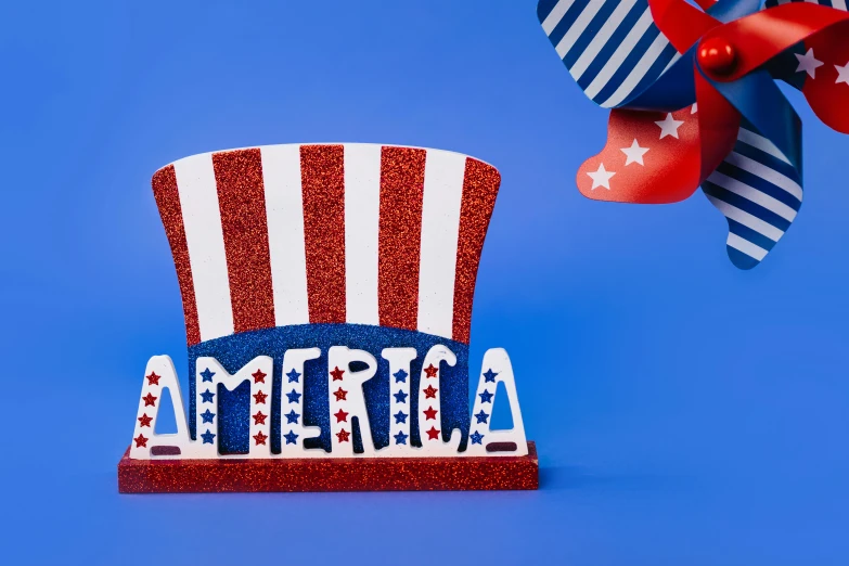 a red, white and blue top hat with a pinwheel, by Julia Pishtar, shutterstock contest winner, pop art, glowforge template, funimation, americana architecture, candy decorations