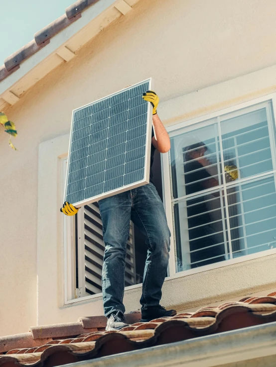 a man standing on top of a roof holding a solar panel, pexels contest winner, renaissance, wires hanging across windows, 🚀🌈🤩, at home, restoration