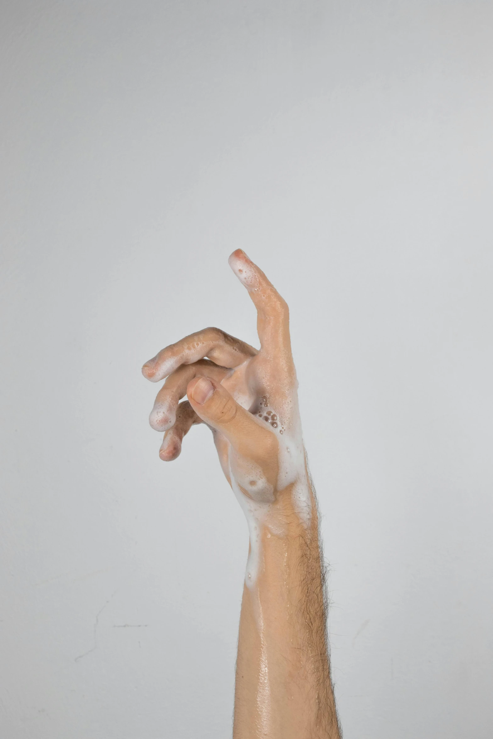 a man is washing his hands with soap, an album cover, by Doug Ohlson, trending on pexels, hyperrealism, graceful arms, patricia piccinini, soft organic abstraction, transparent body