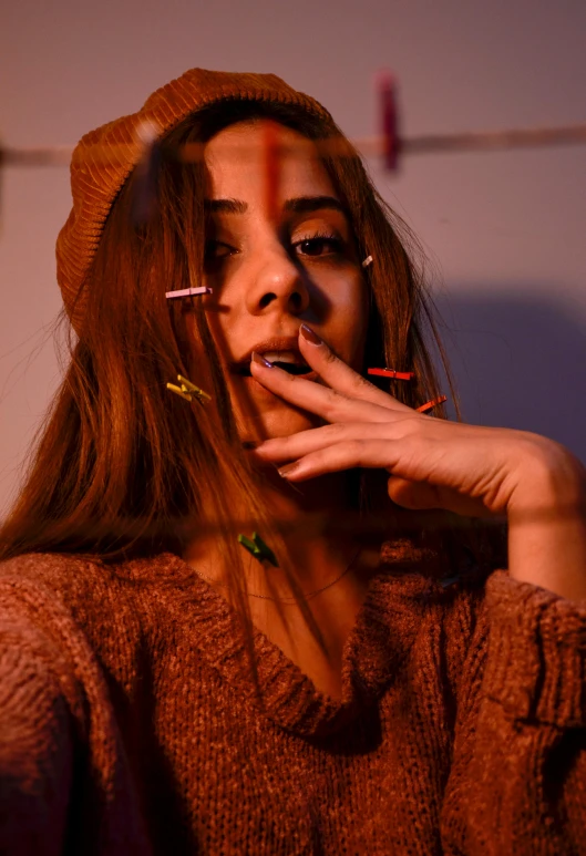 a woman in a brown sweater smoking a cigarette, a picture, inspired by Elsa Bleda, trending on pexels, trippy, teen girl, childish look, taken with sony alpha 9