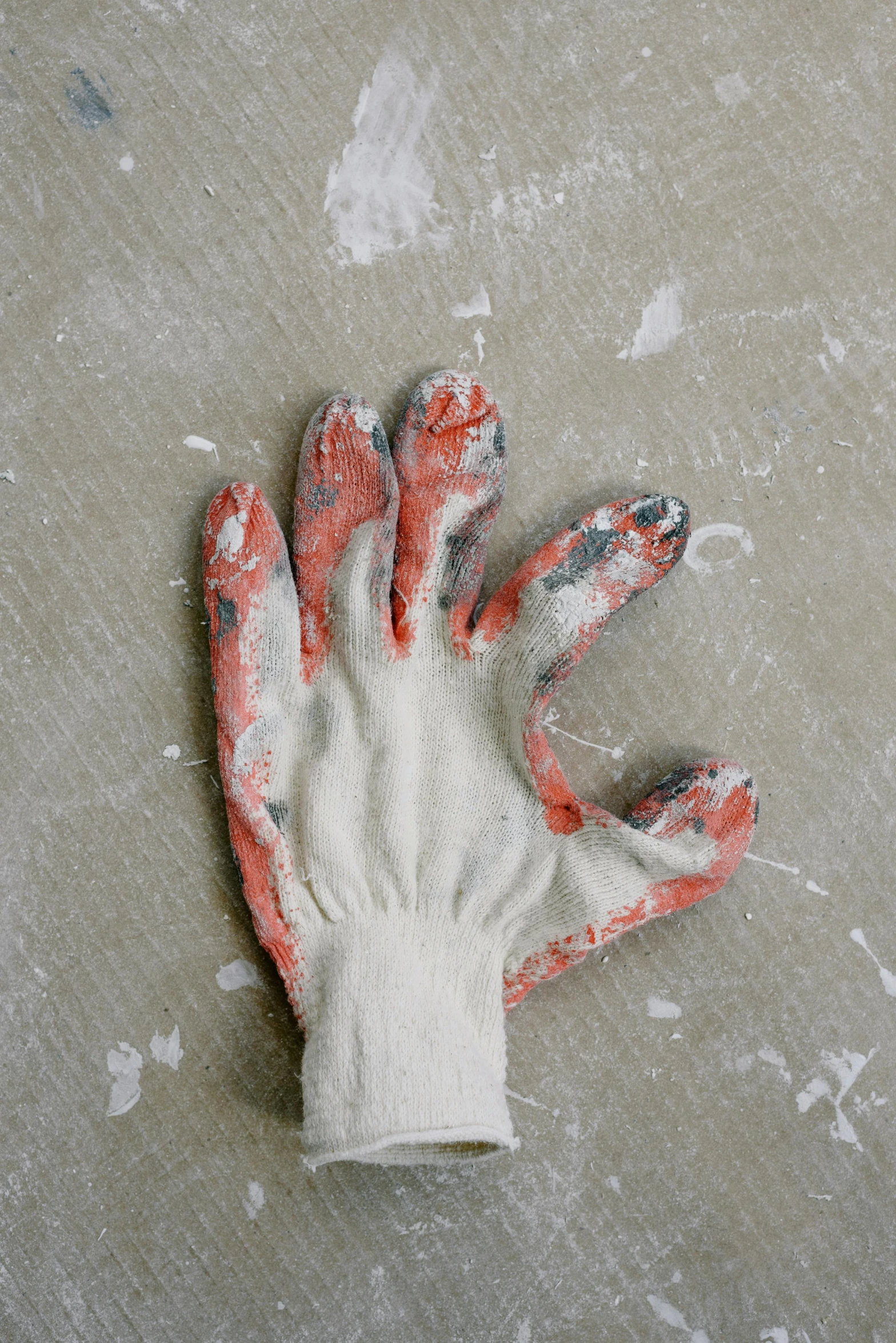 a close up of a glove on a table, a painting, unsplash, arbeitsrat für kunst, made of cement, multi - coloured, maintenance photo