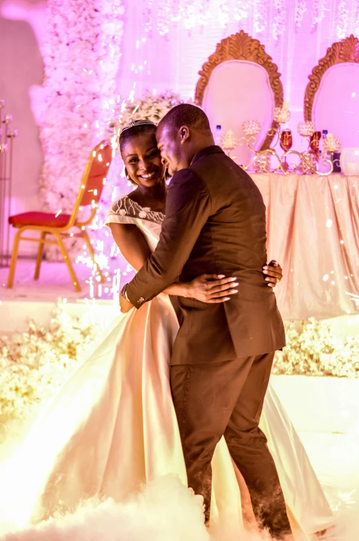 a man and a woman standing in front of a stage, glittery wedding, adut akech, happy couple, ( ( theatrical ) )