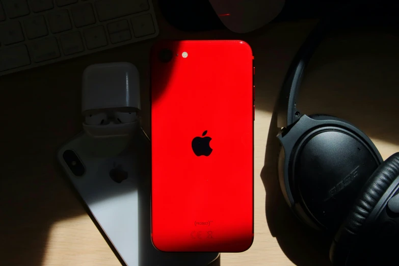 a red iphone sitting on top of a desk next to headphones, trending on pexels, square, reddit post, 🚀🌈🤩, red - black