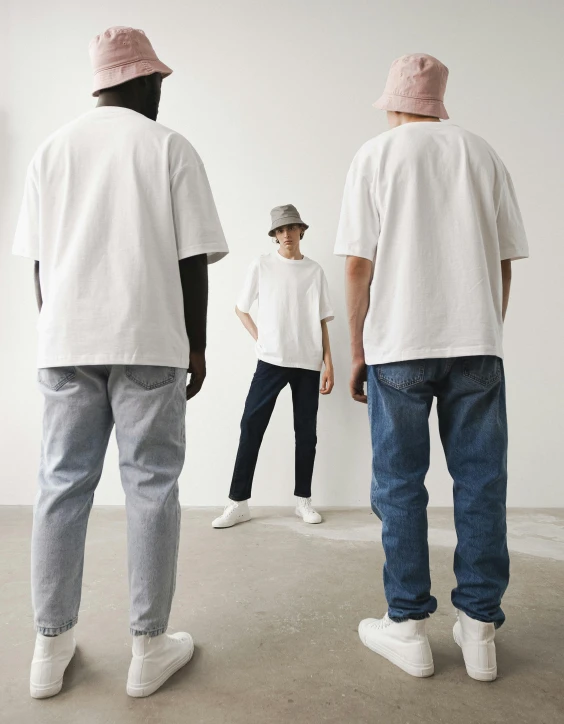 a group of people standing in front of a mirror, inspired by Ai Weiwei, happening, jeans and t shirt, product introduction photo, soft cool tones, baggy clothing and hat