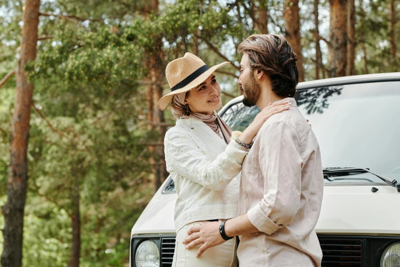 a man and a woman standing in front of a truck, pexels contest winner, romanticism, forest picnic, beige fedora, profile image, white