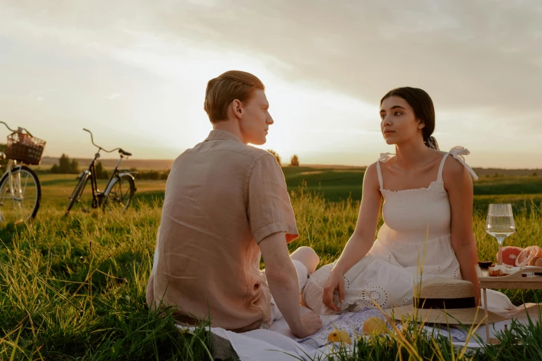 a man and a woman sitting on a blanket in a field, pexels contest winner, renaissance, summer evening, 4 k movie still, romantic lead, ad image