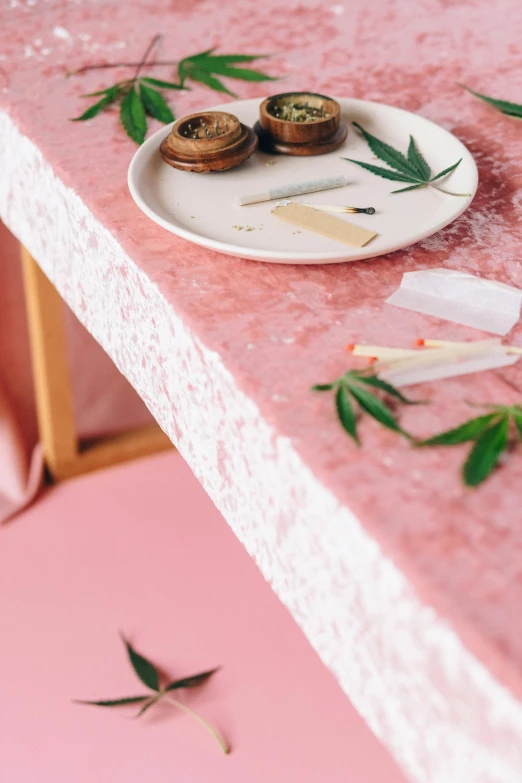 a close up of a plate of food on a table, by Elsa Bleda, renaissance, marijuana themed, pink concrete, fabrics, wedding