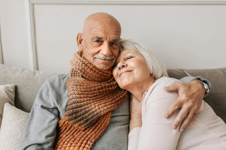 an older man and woman hugging on a couch, pexels contest winner, instagram post, portrait image, ilustration, cute photo