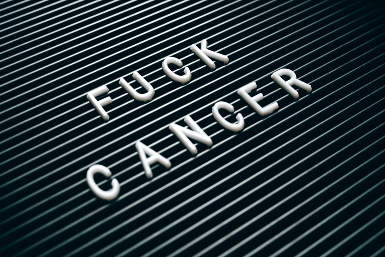 a close up of a metal sign with the word fuck cancer written on it, an album cover, flickr, alessio albi, karim rashid, scanlines, ffffound
