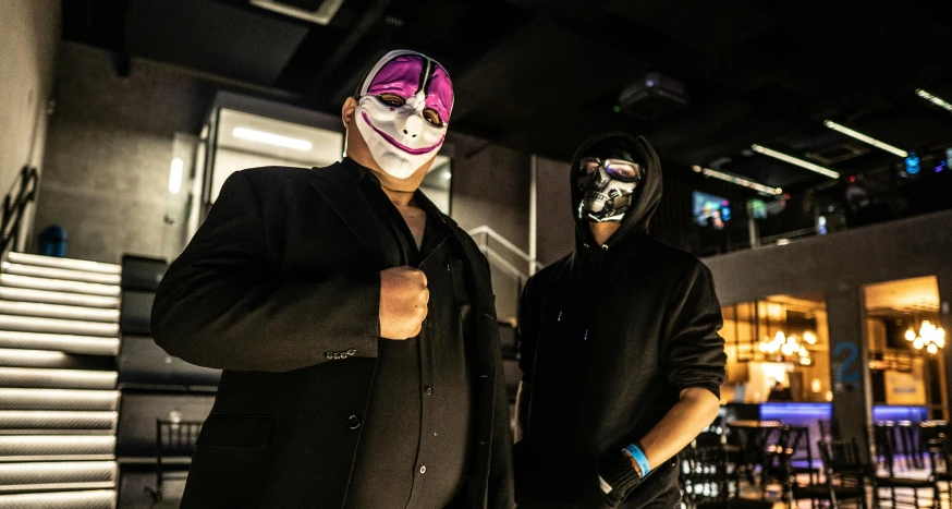 a couple of men standing next to each other, an album cover, unsplash, wearing mask, black and violet costume, wwe, payday 2