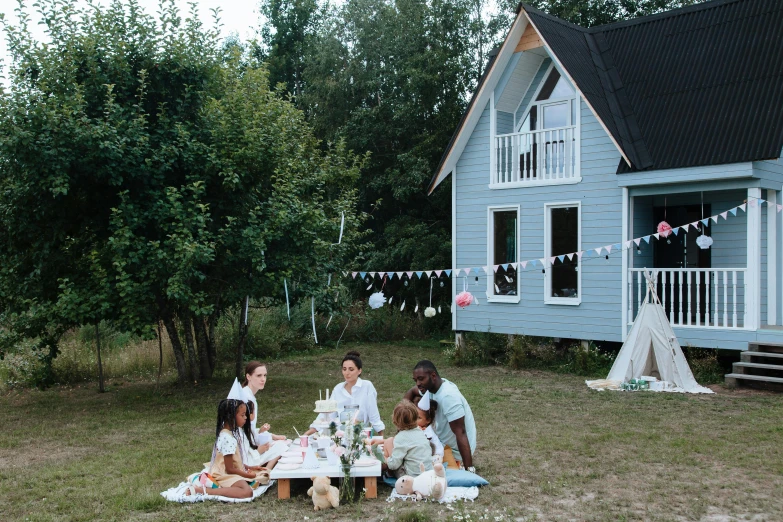 a group of people sitting around a picnic table, doll house, hygge, alexander abdulov, little cottage