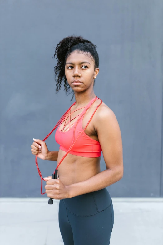 a woman in a sports bra top holding a jump rope, by Nina Hamnett, aida muluneh, square, high quality photo, portait image