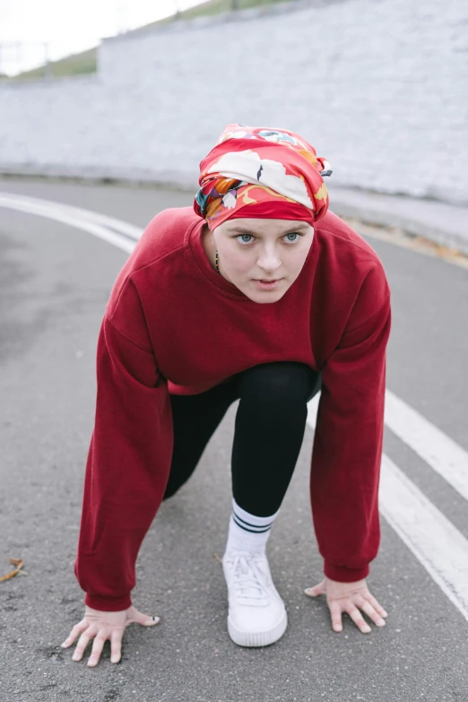 a close up of a person on a skateboard, inspired by Louisa Matthíasdóttir, trending on pexels, red oval turban, wearing sweatshirt, running pose, worried