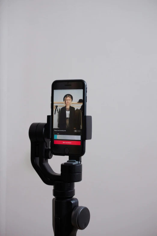 a cell phone sitting on top of a tripod, unsplash, video art, posing robotically, professional headshot, cane, home video