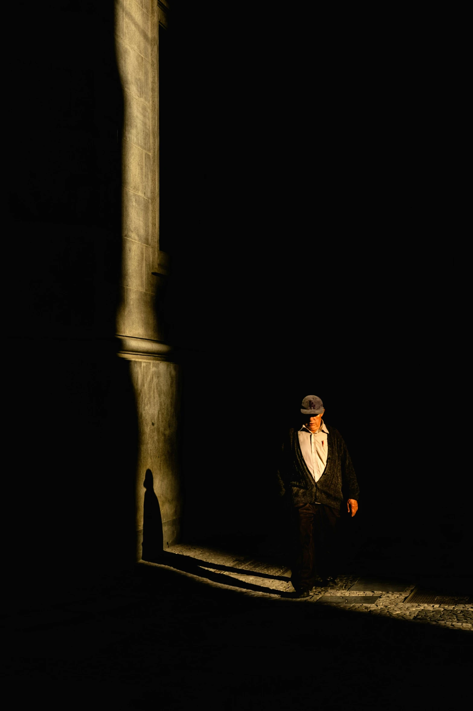 a man in a tuxedo walking in the dark, renaissance, tall columns, production photo, scene from supplizia, hamlet