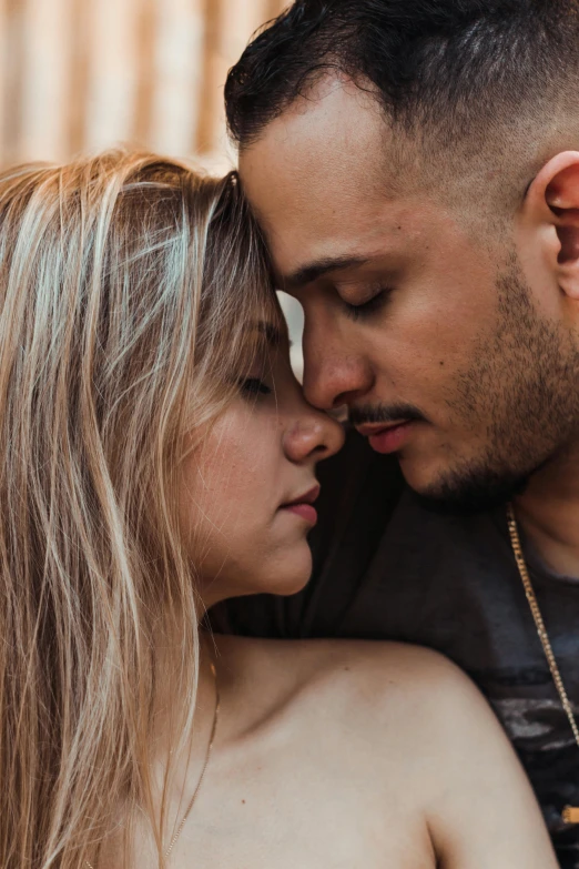 a man and a woman standing next to each other, a photo, trending on pexels, renaissance, intimate holding close, hispanic, blonde man, shaven