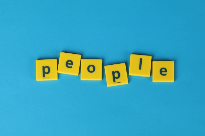 the word people spelled in scrabbles on a blue background, an album cover, by Daniel Lieske, trending on pexels, antipodeans, yellow, anthropologist, customers, the prophet of the common people