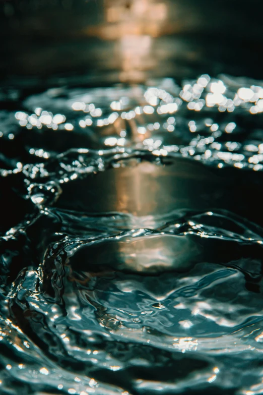 a close up of a water drop in a sink, inspired by Elsa Bleda, trending on unsplash, renaissance, made of liquid metal, whirlpool, water pipe, underwater glittering river