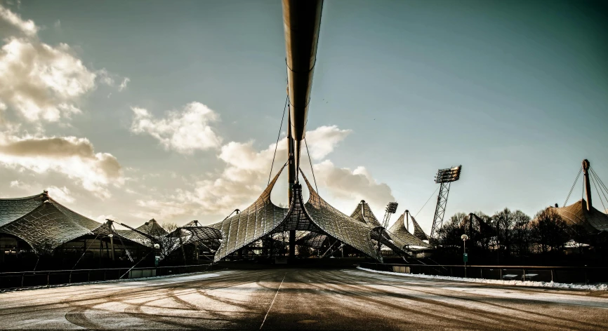 a black and white photo of a bridge, by Tobias Stimmer, unsplash contest winner, brutalism, stadium setting, asymmetrical spires, golden curve structure, post processed