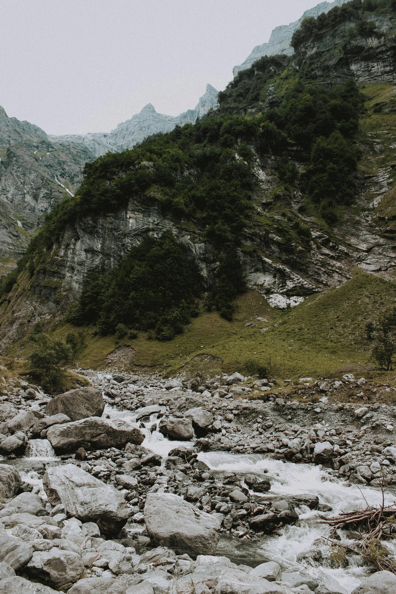 a mountain stream running through a rocky valley, a picture, unsplash contest winner, naturalism, 2 5 6 x 2 5 6 pixels, alps, looking sad, grey