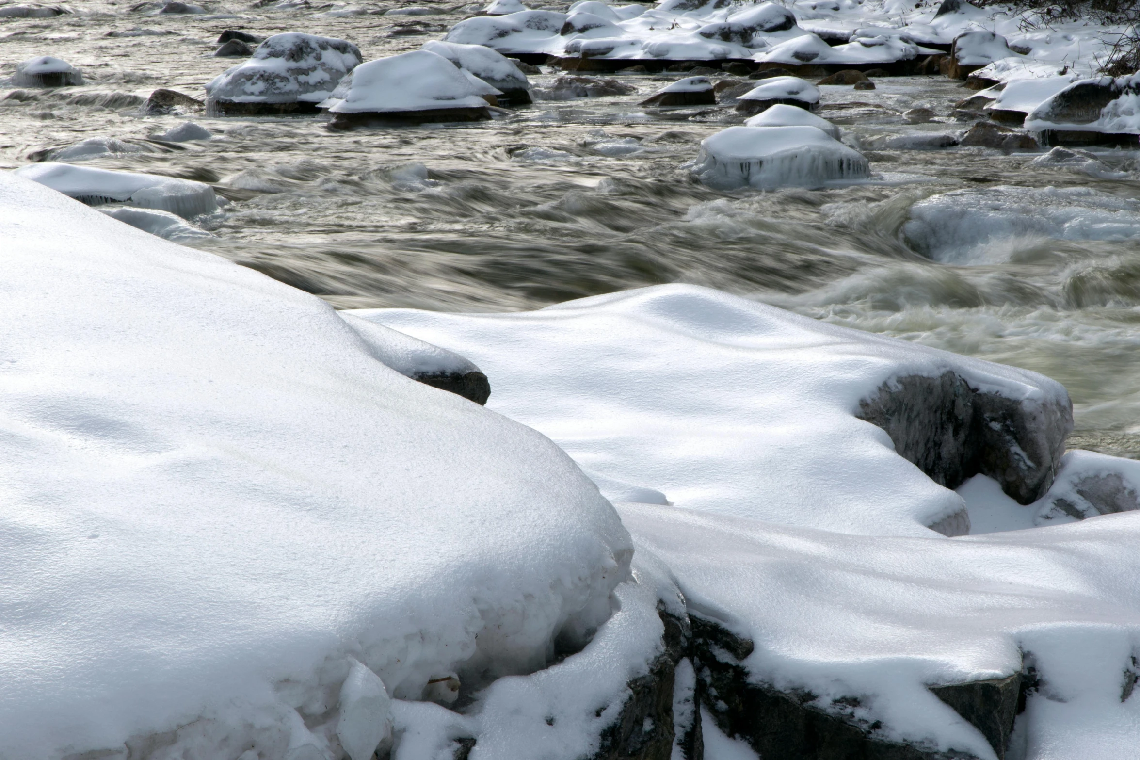 a red fire hydrant covered in snow next to a river, a picture, pexels contest winner, white water rapids, rocks, thumbnail, gray