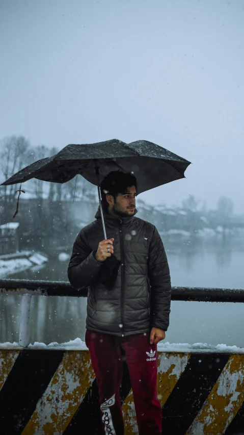 a man standing on a bridge holding an umbrella, pexels contest winner, an afghan male type, wintermute, thumbnail, high quality photo