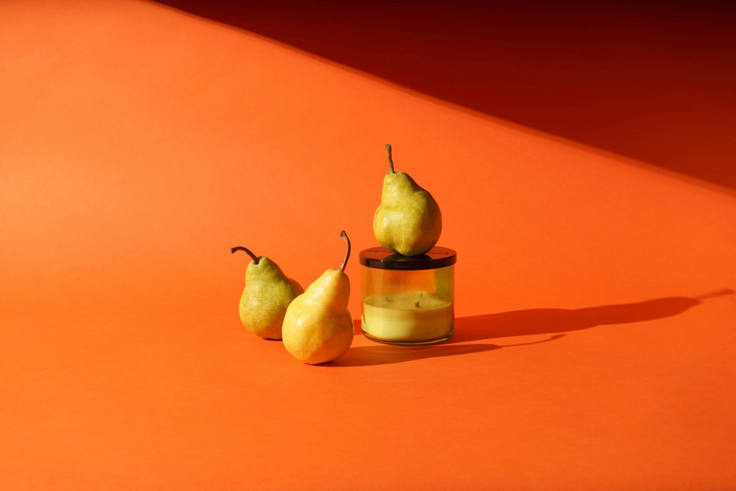 a couple of pears sitting on top of a table, a still life, inspired by Lubin Baugin, unsplash, yellow walls, glowing jar, orange subsurface scattering, high resolution product photo