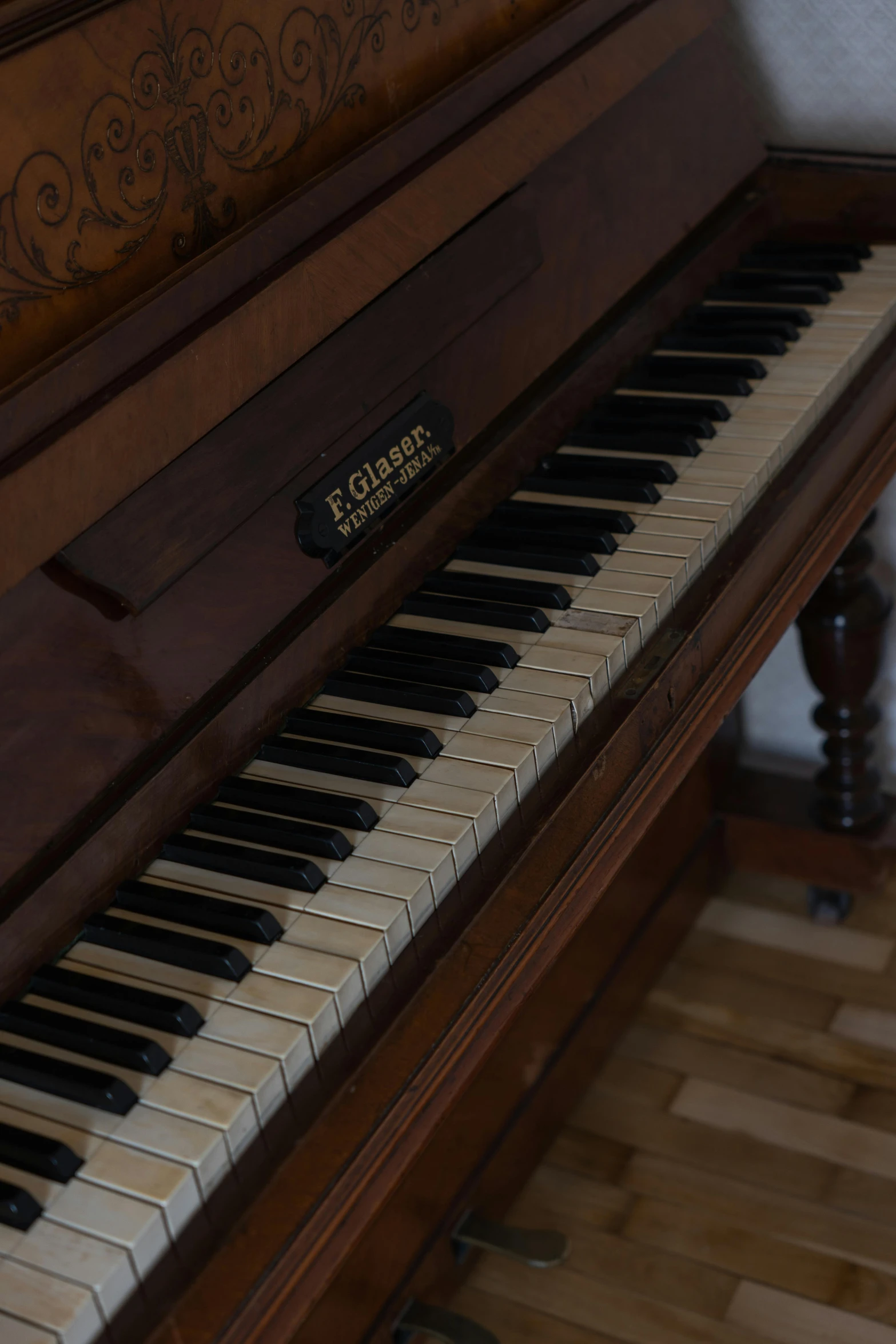 a piano sitting on top of a hard wood floor, by Elias Goldberg, elliot anderson, up-close, elevation, brown