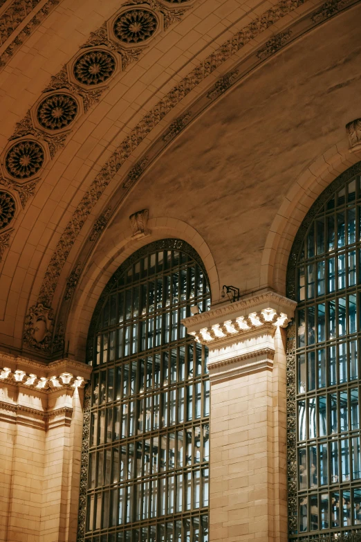 a clock mounted to the side of a building, by Alison Geissler, trending on unsplash, art nouveau, interior of a marble dome, 2 5 6 x 2 5 6 pixels, new york buildings, tall arched stone doorways