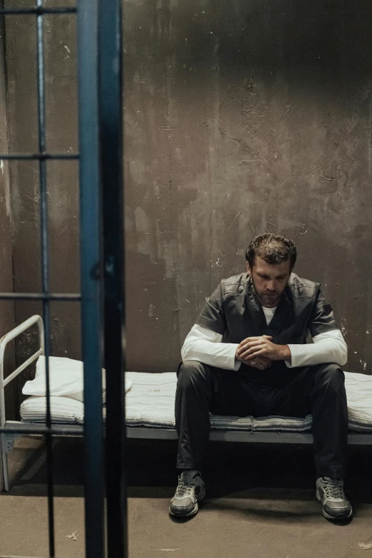 a man sitting on a bed in a jail cell, trending on pexels, antony starr, heartbreak, herry cavill, 15081959 21121991 01012000 4k