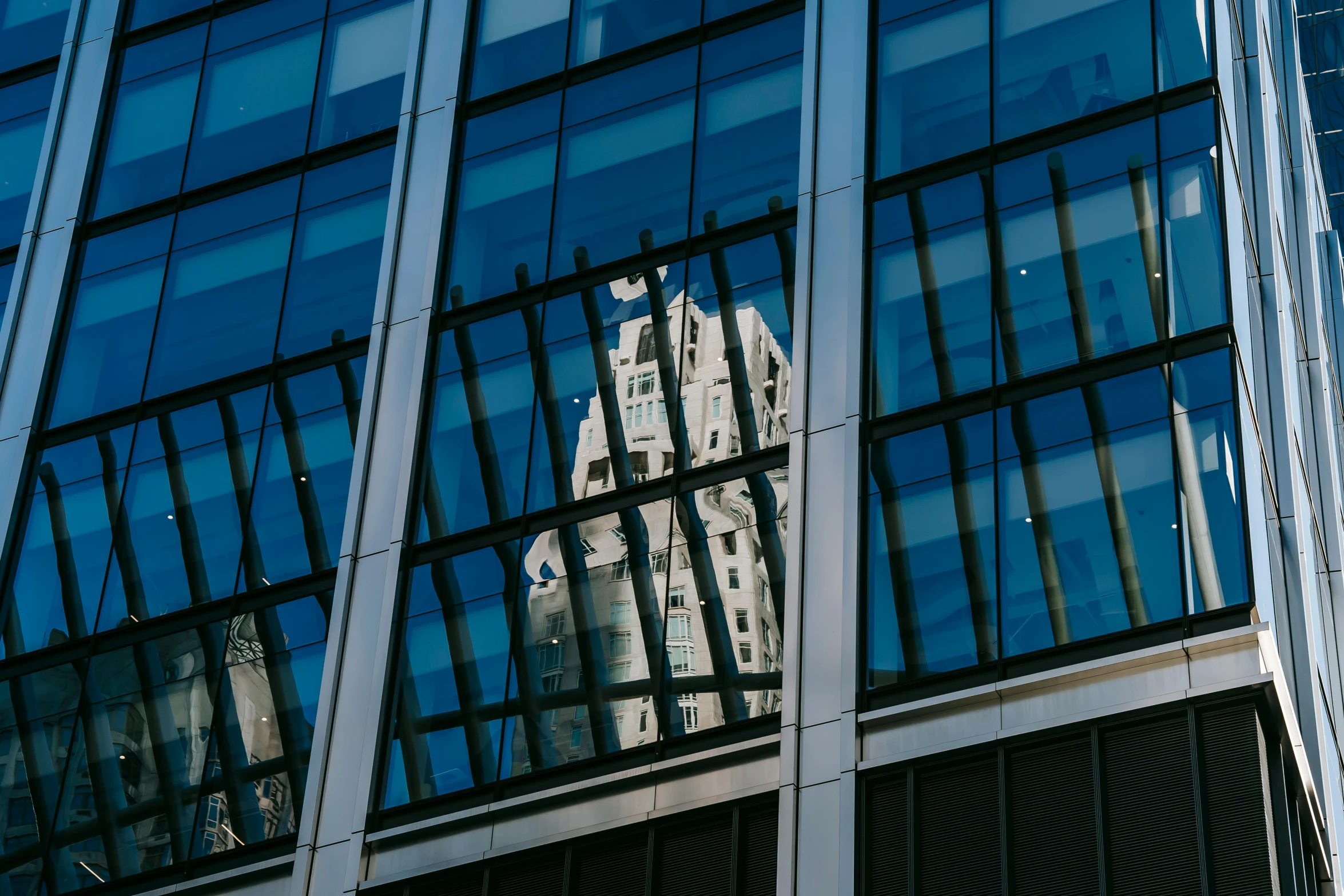 a building is reflected in the windows of another building, a photo, pexels contest winner, chicago, thumbnail, multiple stories, medium closeup shot