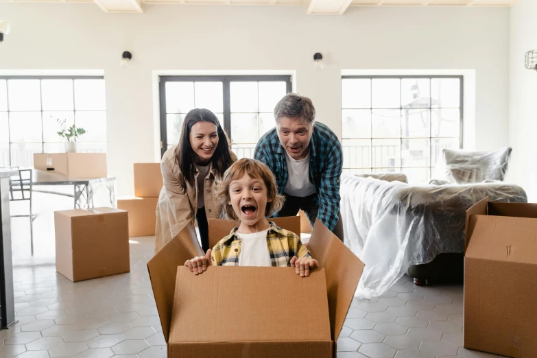 a man and woman standing next to a child in a cardboard box, pexels contest winner, thumbnail, australian, having a great time, ergonomic