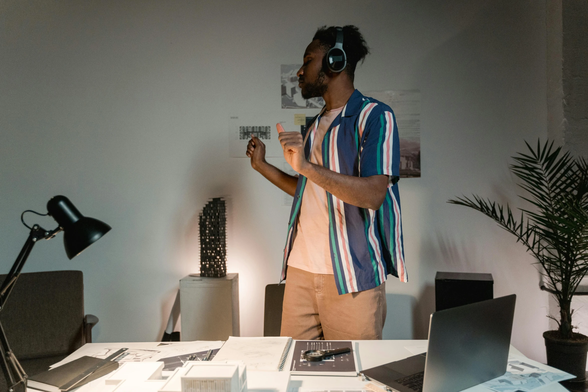 a man standing in front of a laptop computer, an album cover, pexels contest winner, in an call centre office, cinematic outfit photo, architect, mkbhd
