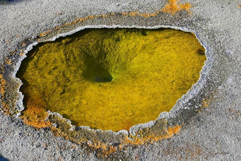 a close up of a hole in the ground, by Jan Rustem, featured on pixabay, land art, sulfur, square, full of greenish liquid, yellow