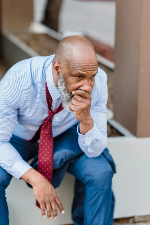 a man sitting on the steps of a building, inspired by William H. Mosby, pexels contest winner, renaissance, looking exhausted, wearing a shirt with a tie, middle aged man, atiba jefferson