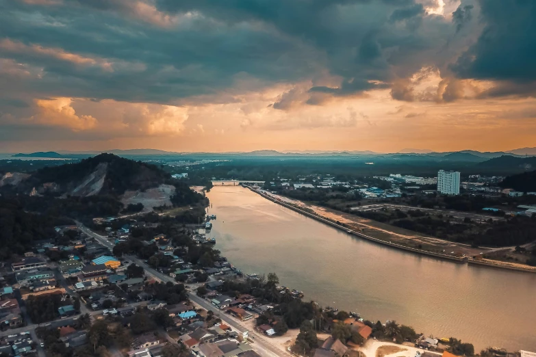 an aerial view of a city with a river running through it, pexels contest winner, dramatic sky, guwahati, cinematic 4k wallpaper, aerial view cinestill 800t 18mm