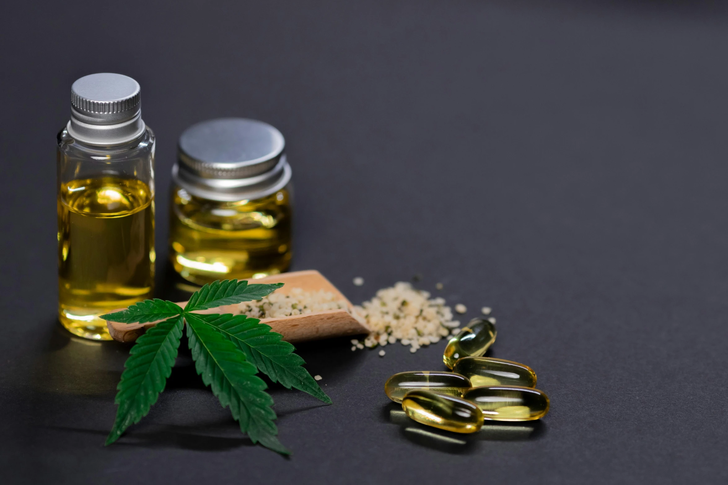 a close up of a bottle of oil next to a pair of scissors, 4 cannabis pots, against dark background, clinical, lumi