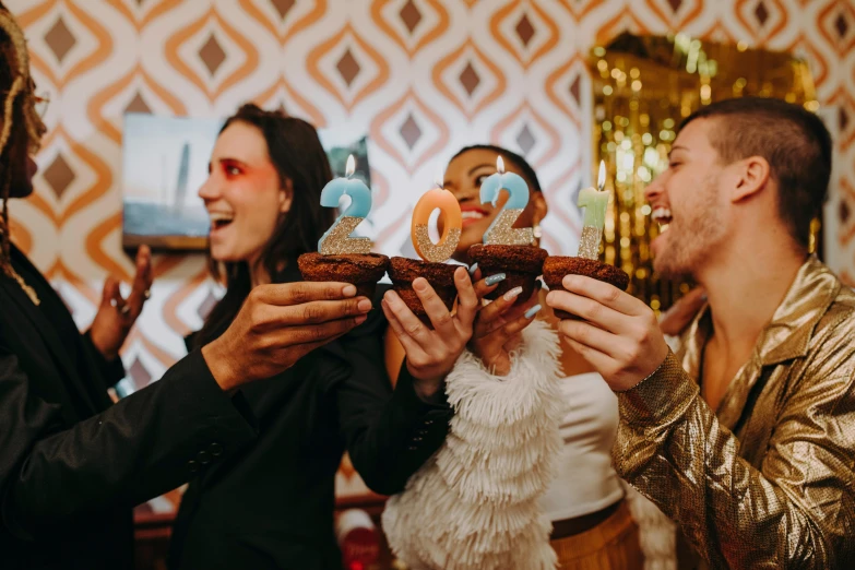 a group of people eating doughnuts at a party, by Julia Pishtar, trending on pexels, happening, new years eve, 2 0 2 0 s promotional art, holding it out to the camera, background image