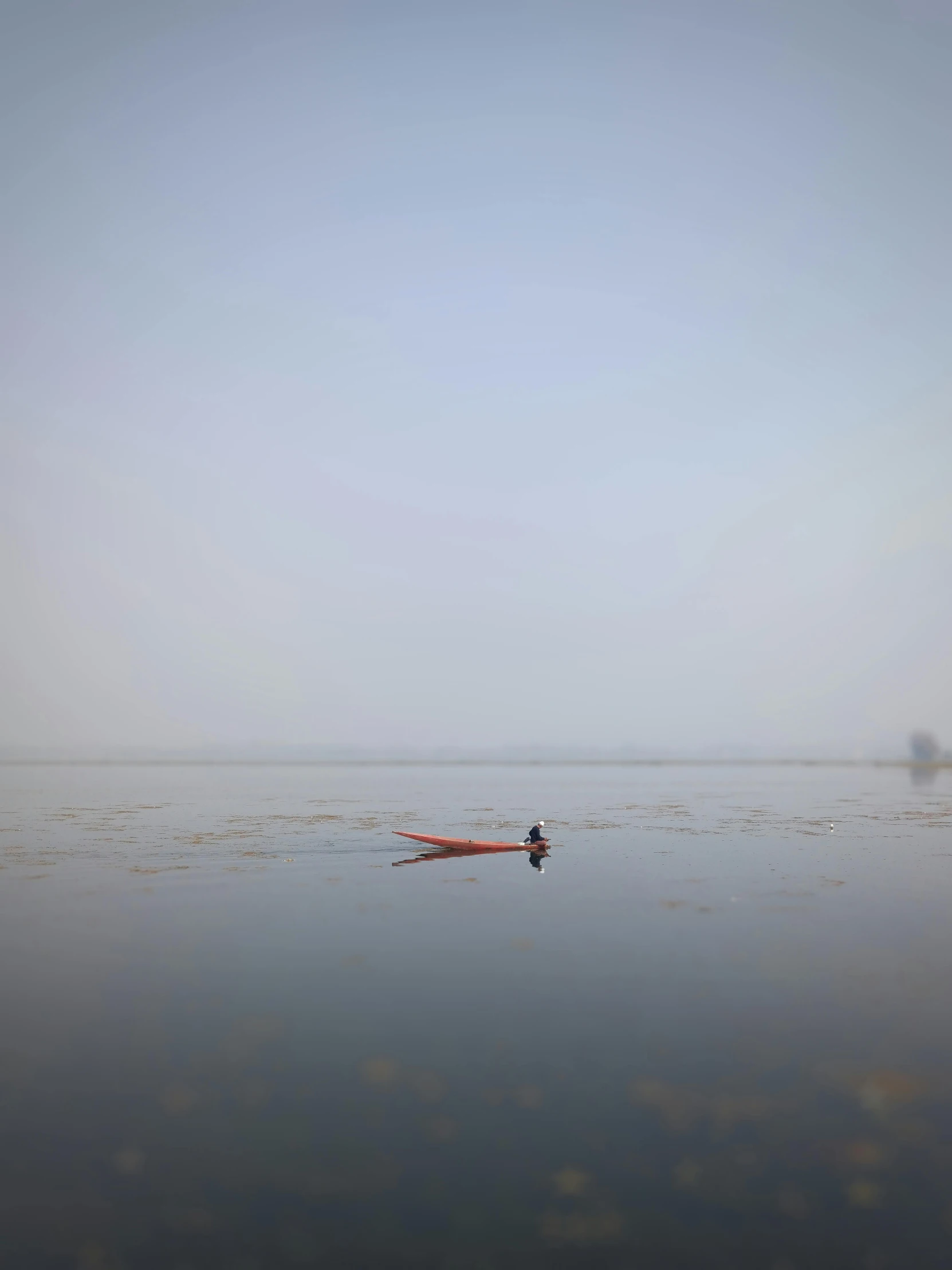 a person in a kayak in the middle of a body of water, by Tobias Stimmer, minimalism, guwahati, slightly foggy, promo image, joel sternfeld