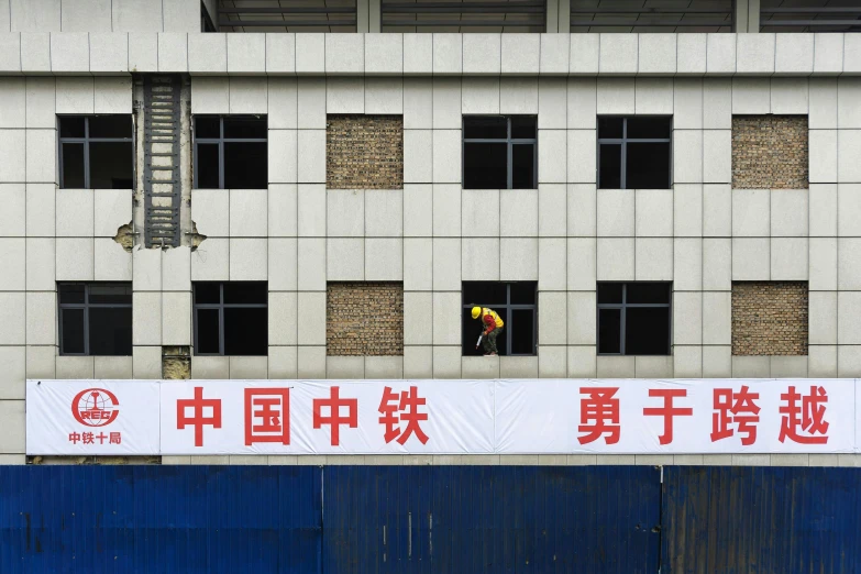 a man that is standing in front of a building, inspired by Zhang Kechun, bright signage, feng zhu |, workers, gettyimages