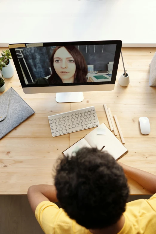 a man sitting at a desk in front of a computer, a digital rendering, trending on pexels, video art, teacher, photograph credit: ap, person in foreground, julia sarda