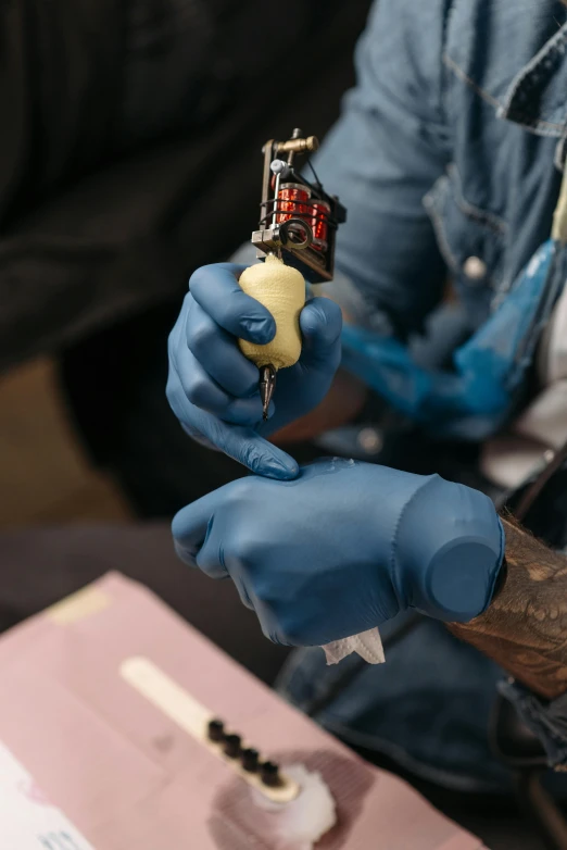 a man getting a tattoo on his arm, trending on unsplash, process art, lightblue acrylic paintdrip tar, hand grenades, 3 d print, vintage color