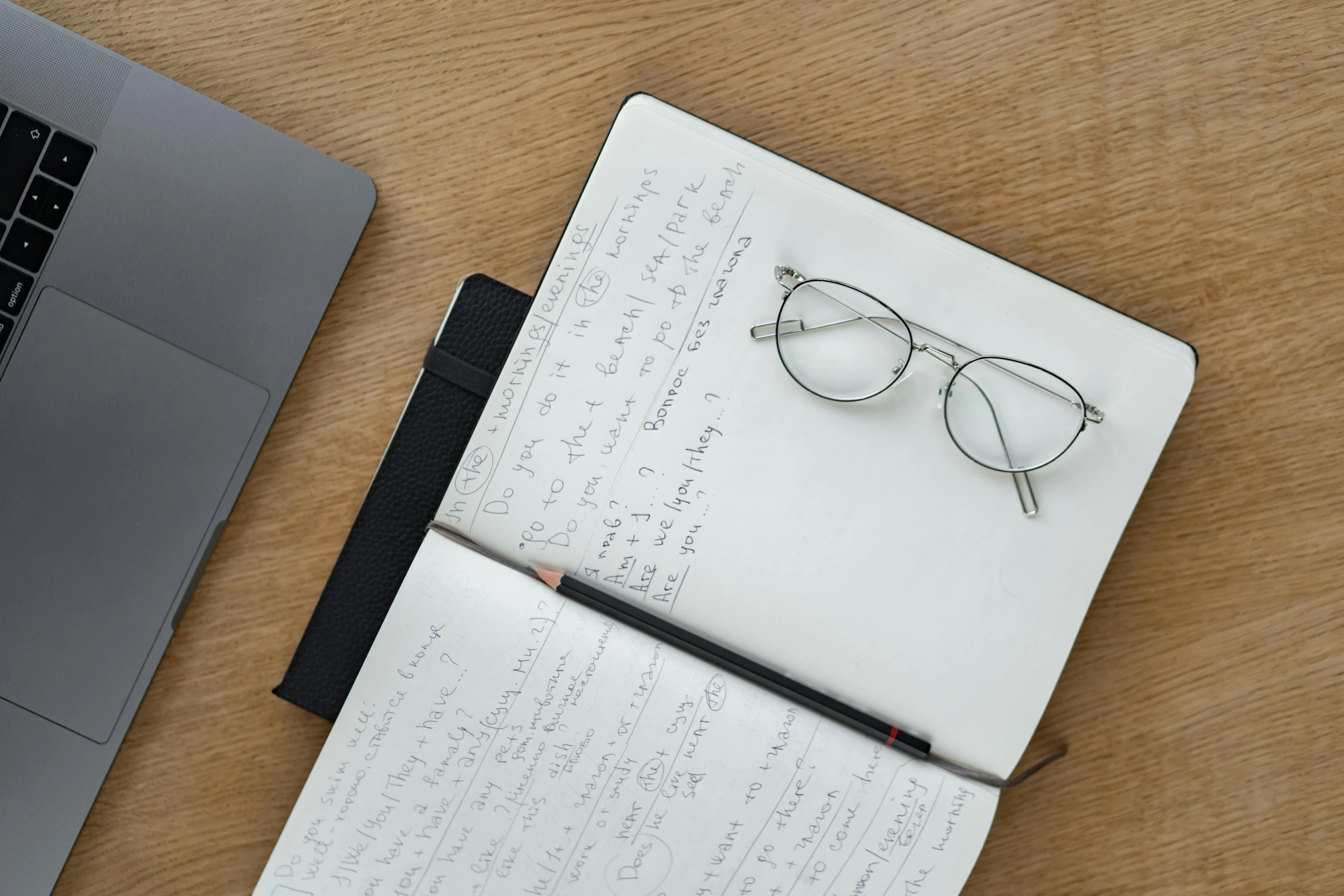 a notebook with a pen and glasses next to a laptop, by Carey Morris, birdseye view, square glasses, detail shot, a list cast