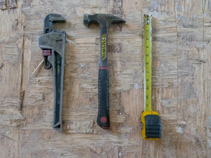 a couple of tools sitting on top of a wooden floor, rule of threes, imgur, well worn, measurements